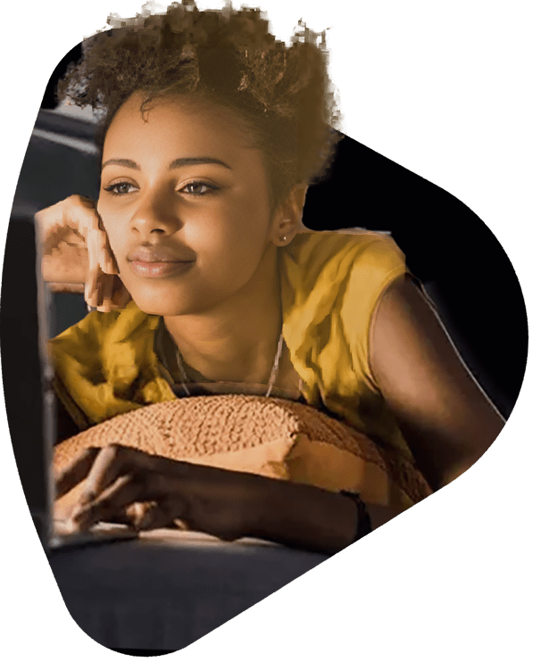 a young woman watching a show on her laptop